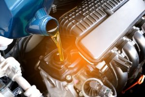 RefuelingAndPouringOilQualityIntoTheEngineMotorCar - Meineke Missouri Meineke Car Care | Oil Changes | Crystal City MO